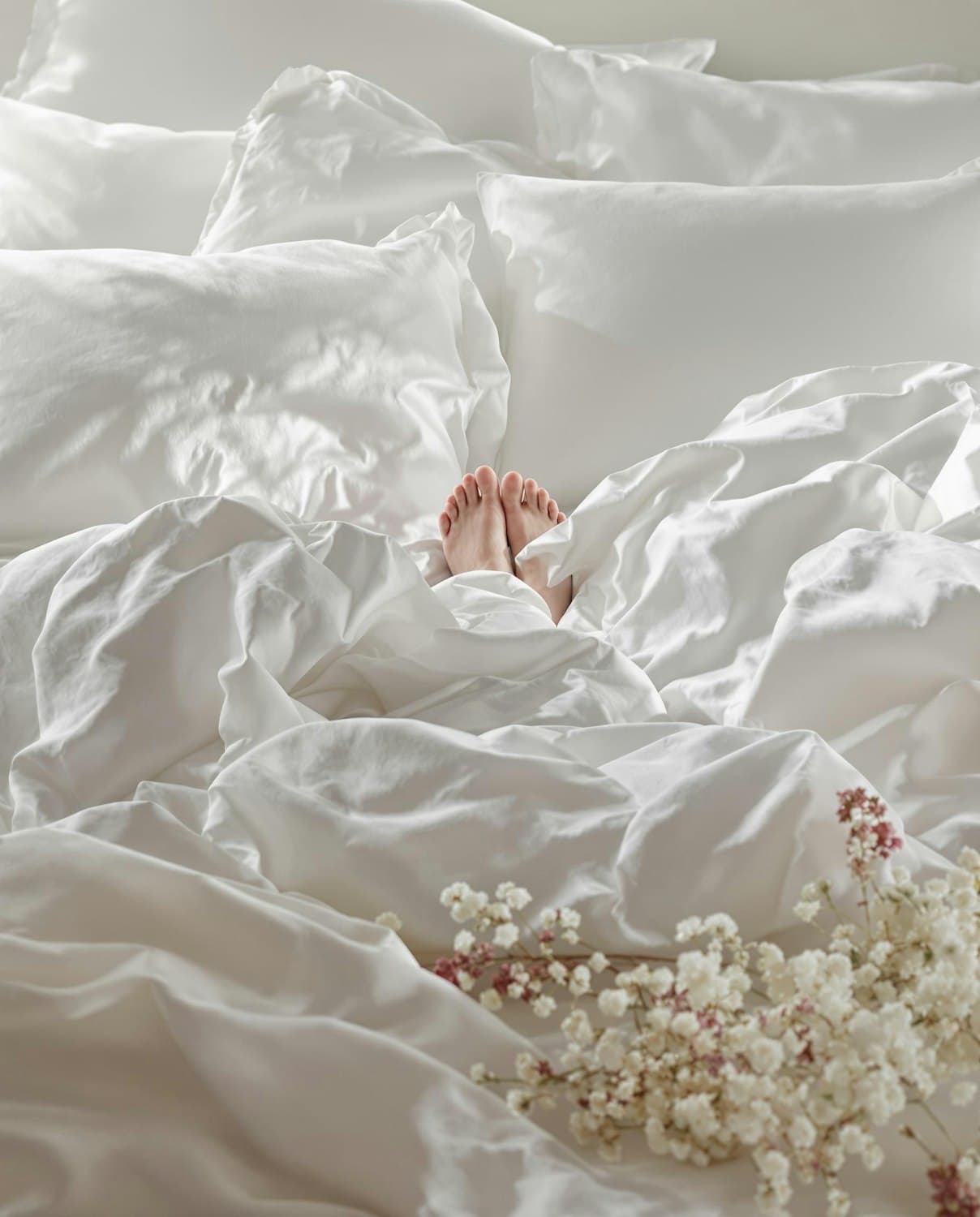 A made bed with soft white linen